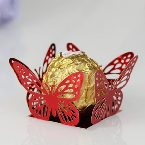 Macro shot of red laser-cut butterfly chocolate holder with intricate hollow patterns