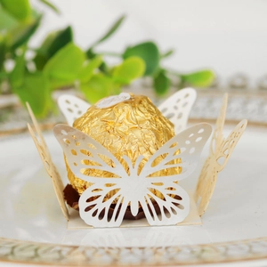 Close-up of white laser-cut butterfly chocolate holder for party favors