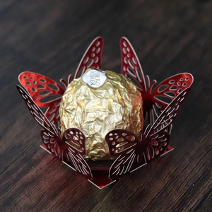 Detailed laser-cut butterfly wrapper in red for chocolates and wedding party favors