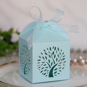 Detail of light blue laser-cut tree gift box with pearl paper finish and organza ribbon