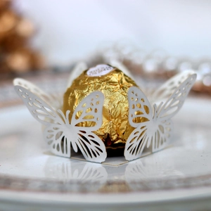 Detailed laser-cut butterfly chocolate holder for wedding parties in white cardstock
