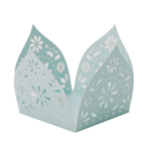 Close-up of laser-cut floral light blue cupcake wrappers for wedding party decorations