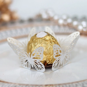 Laser-cut white butterfly chocolate wrapper with intricate patterns for party favors