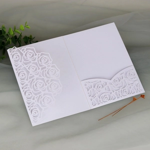 Detail of white laser-cut rose floral wedding invitation sleeve with inner pocket