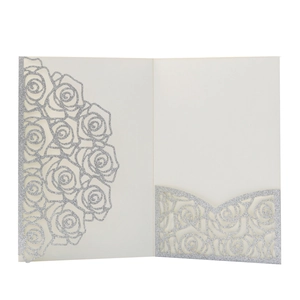 Detailed laser-cut rose hollow pattern on cream cardstock with silver glitter finish