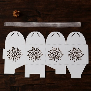 Flat lay of laser-cut Tree of Life candy box template with a matching silk ribbon