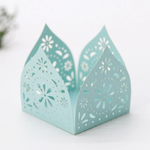 Close-up of light blue laser-cut hollow floral pattern on a square gift box decorative wrap