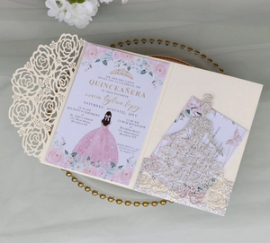 Detail of laser-cut glitter rose invitation with golden crown and princess silhouette