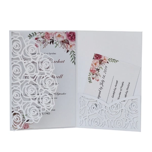 Detail of laser-cut rose hollow pocket and watercolor floral wedding invitation set