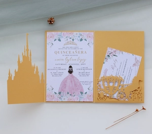 Detailed laser-cut gold wedding invitation with castle silhouette and princess design
