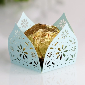 Detail showing laser-cut floral pattern and scalloped edges on light blue candy wrapper