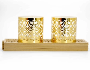Macro detail of laser-cut gold cupcake liners with elegant floral filigree pattern