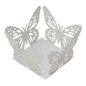 Macro detail of white laser-cut butterfly candy box with pearlescent finish and lace patterns