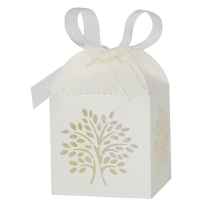 Detail of laser-cut tree design on white gift box with elegant organza ribbon bow