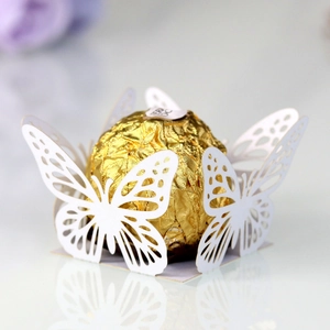 Detail of white laser-cut butterfly chocolate wrapper with elegant pearl finish paper