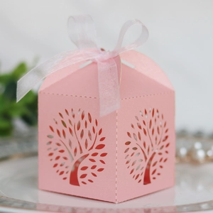 Laser cut pink wedding favor box with hollow tree design and sheer ribbon bow detail