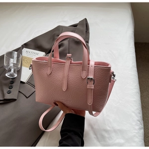 Pink crocodile pattern handbag on white linen with blazer for a lifestyle fashion look