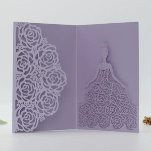 Macro detail of laser-cut hollow rose floral pattern on elegant purple wedding invitation