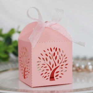 Detailed laser-cut tree of life wedding favor box in pink cardstock with organza ribbon