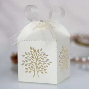 Detailed laser-cut tree of life candy box with white organza ribbon for weddings