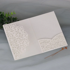 Detailed laser-cut rose hollow pattern on white pearlescent paper invitation card