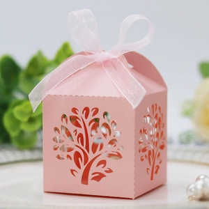 Pink laser-cut candy gift box with tree pattern and ribbon for party favors