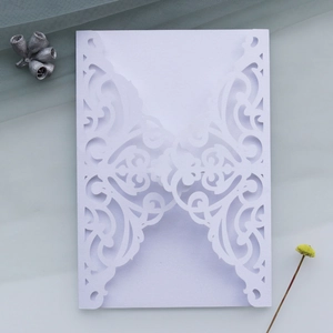 Detailed laser-cut lavender pearl paper invitation with elegant floral lace pattern
