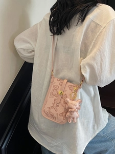 Pink crossbody phone bag with teddy bear print and cute 3D bear charm accessory