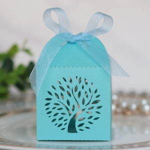 Close-up of light blue laser-cut tree gift box with elegant organza ribbon bow