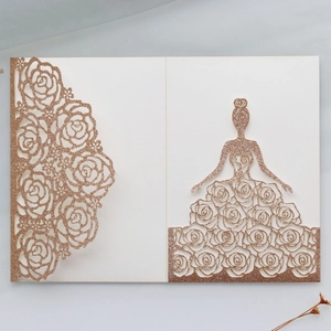 Close-up of rose gold glitter laser cut wedding invitation with floral and girl silhouette