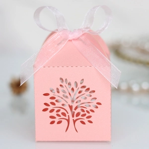 Detail of pink laser-cut Tree of Life candy box with elegant white organza ribbon bow