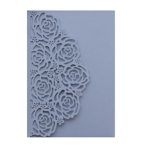 Detailed close-up of laser-cut rose patterns on lavender purple wedding invitation cover