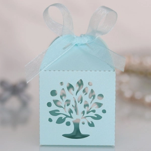Detail of light blue laser-cut Tree of Life candy box with elegant organza ribbon bow