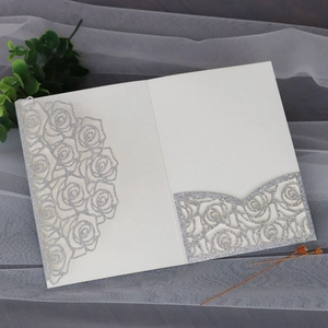 Detailed laser-cut ivory rose pattern invitation with sparkling silver glitter finish