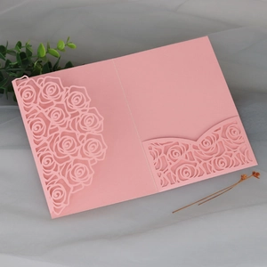 Pink laser-cut rose wedding invitation cover on elegant grey tulle background