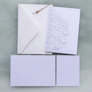 Detail of rose laser-cut wedding invitation set with pearlized paper and envelope