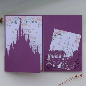 Close-up of laser cut purple castle invitation with elegant pink floral RSVP cards