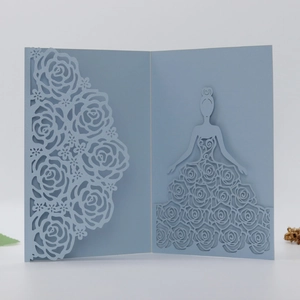 Detail of laser-cut rose floral pattern and elegant girl silhouette on light blue card