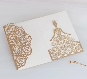 Detail of laser-cut glitter wedding invitation featuring rose patterns and girl silhouette
