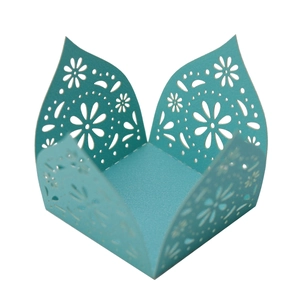 Macro view showing the intricate laser-cut daisy patterns on the turquoise cardstock
