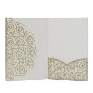 Macro view of laser-cut rose floral wedding invitation in shimmering silver glitter