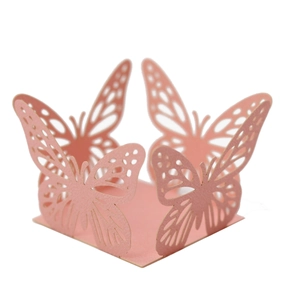 Detail of laser-cut pink butterfly cupcake wrappers for festive party candy decoration