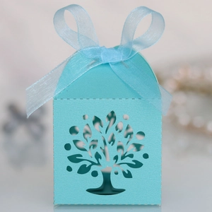 Detail of laser-cut Tree of Life candy box in light blue with matching ribbon bow