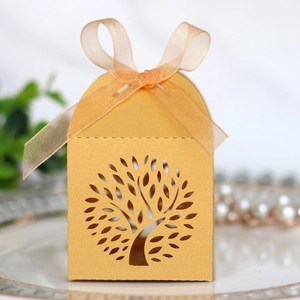 Close-up of golden Tree of Life laser-cut candy box with ribbon and pearl accents