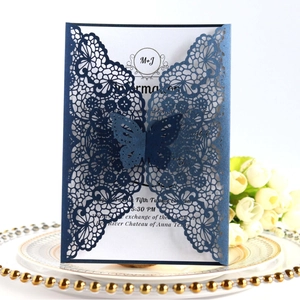 Elegant laser cut navy blue wedding invitation with butterfly and white tulip bouquet