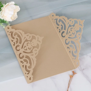 Macro detail of laser-cut floral pattern on elegant pearlescent champagne paper card