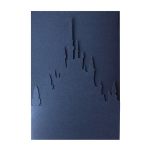 Laser-cut navy blue castle silhouette card with intricate hollowed details and matte texture