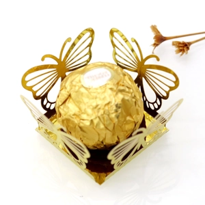 Close-up of golden laser-cut butterfly hollow candy box with intricate wing detail