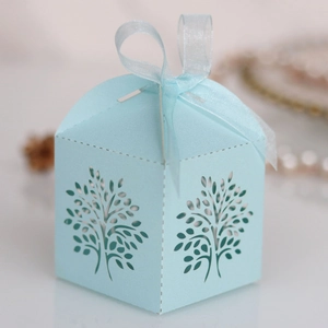 Close-up of laser-cut tree design on tiffany blue candy box with organza ribbon