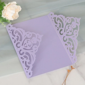 Detailed laser-cut purple invitation cover with intricate floral scrollwork for weddings